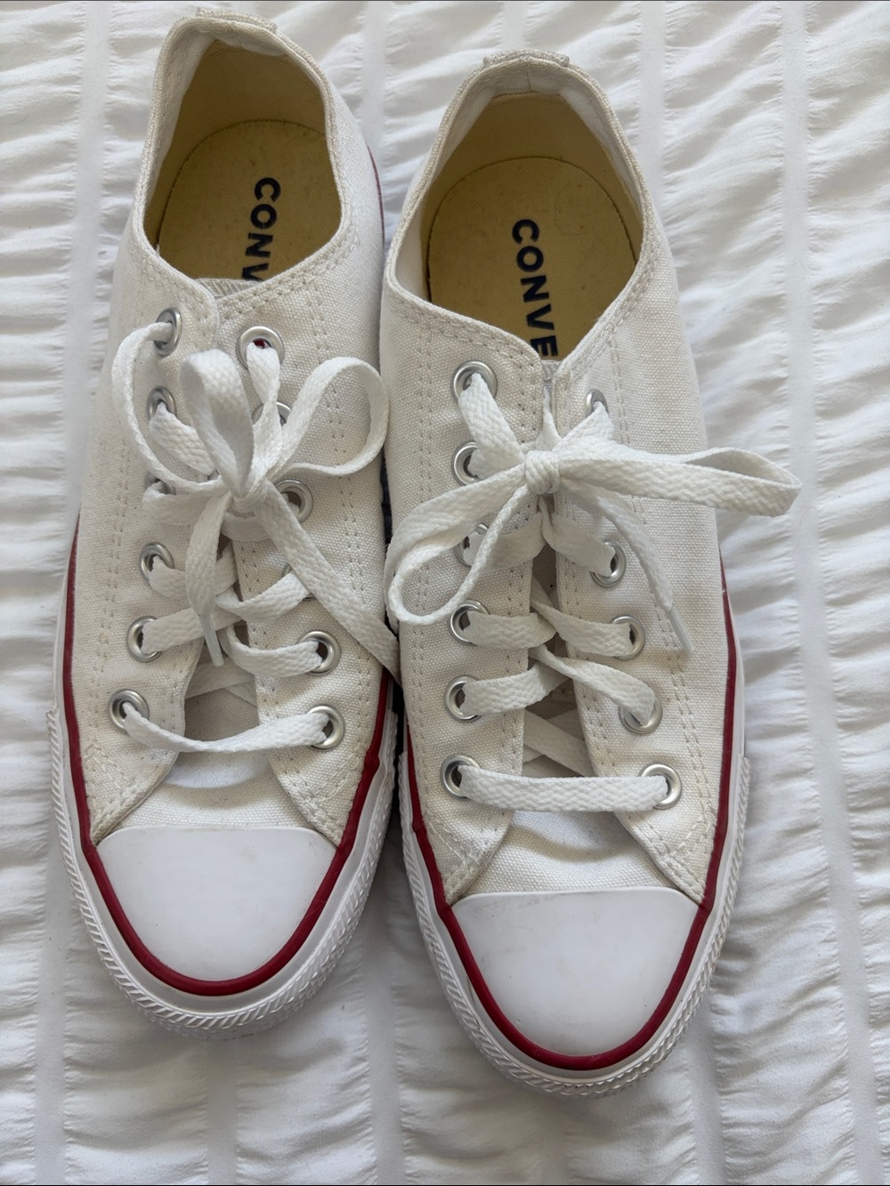 Converse All-Star White Low-Top Sneakers with Red/Blue Stripes.